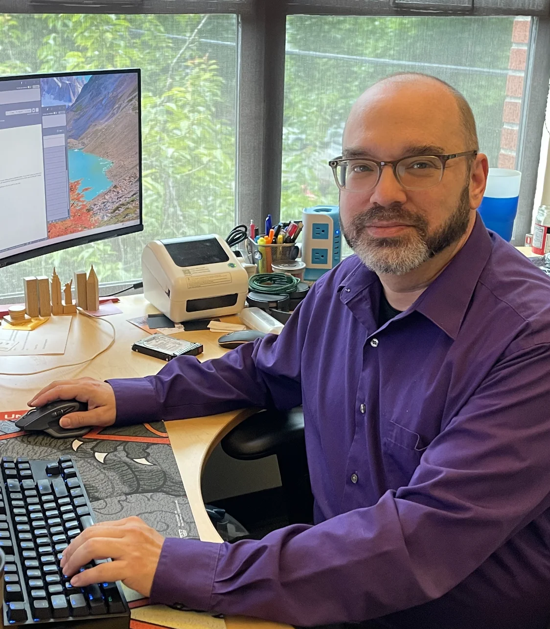 Photo of Adam at his desk